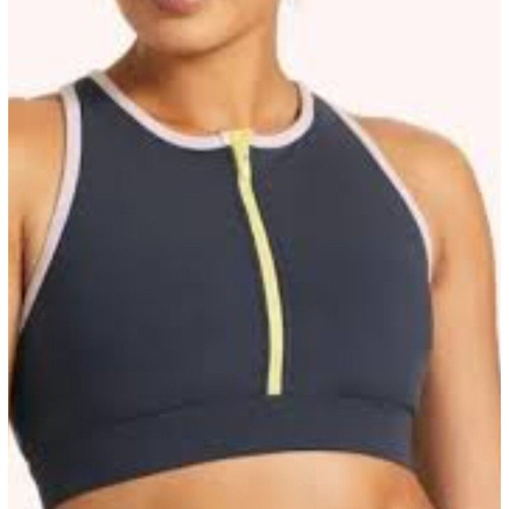 This item is the Peloton Cadent High Neck Zip Bra. It features a...
